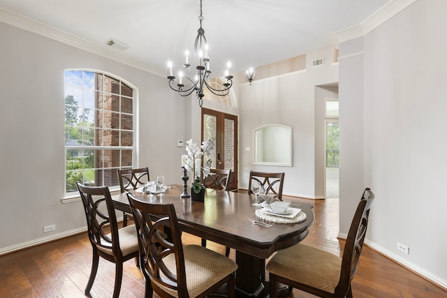 dining area with baseboards, visible vents, a chandelier, and dark wood finished floors