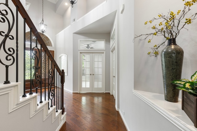 4911 Ontonagon Way, Spring, TX 77386 - entryway featuring healthy amount of natural light, dark wood finished floors, stairway, baseboards, and a high ceiling