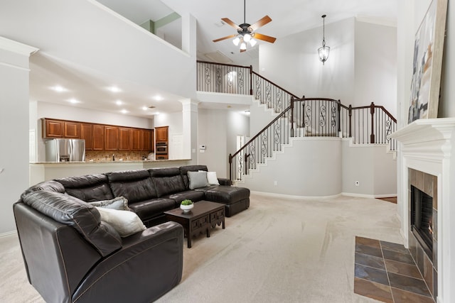 4911 Ontonagon Way, Spring, TX 77386 - carpeted living room featuring ceiling fan, stairway, high vaulted ceiling, baseboards, and a tiled fireplace
