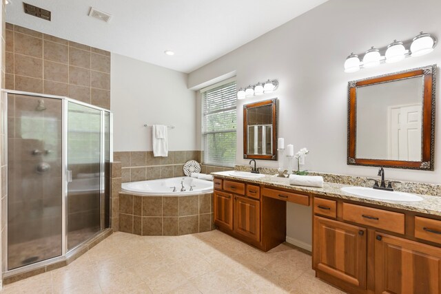 4911 Ontonagon Way, Spring, TX 77386 - full bathroom with double vanity, a stall shower, tile patterned flooring, a garden tub, and recessed lighting