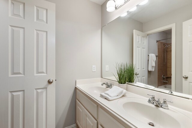 full bathroom featuring double vanity and a sink