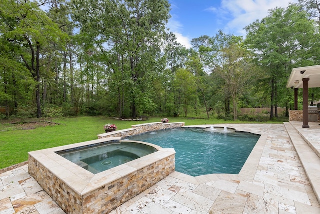 view of pool with a patio, a pool with connected hot tub, and a yard
