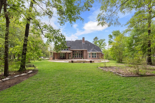 4911 Ontonagon Way, Spring, TX 77386 - back of property featuring a patio area, a yard, and a chimney