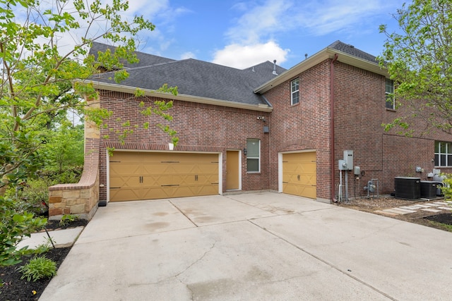 4911 Ontonagon Way, Spring, TX 77386 - view of side of home featuring brick siding, roof with shingles, concrete driveway, and central AC