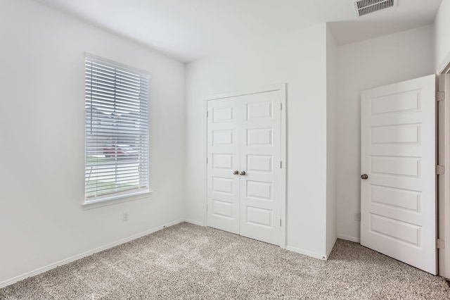 25617 Microstar Way, Montgomery, TX 77316 - unfurnished bedroom with light carpet, baseboards, and a closet