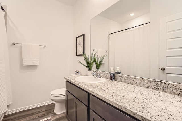 25617 Microstar Way, Montgomery, TX 77316 - bathroom with wood finished floors, vanity, toilet, and baseboards