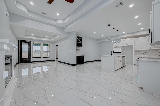 unfurnished living room with marble finish floor, visible vents, recessed lighting, and a raised ceiling