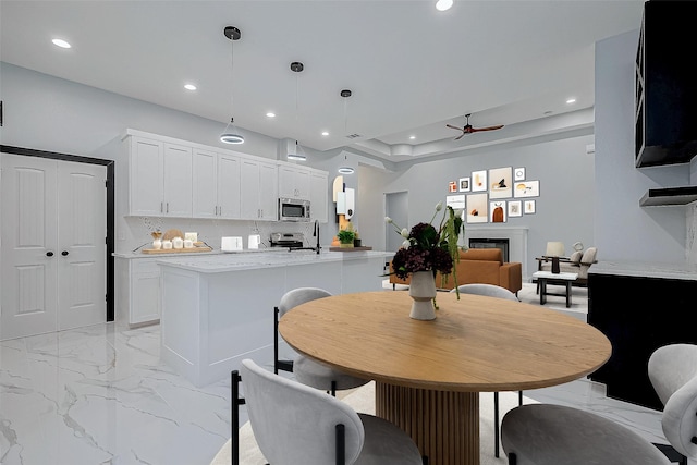 dining space featuring marble finish floor, recessed lighting, and ceiling fan