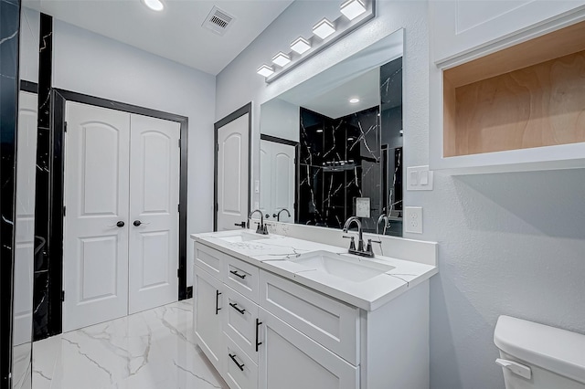 bathroom with a sink, marble finish floor, visible vents, and toilet