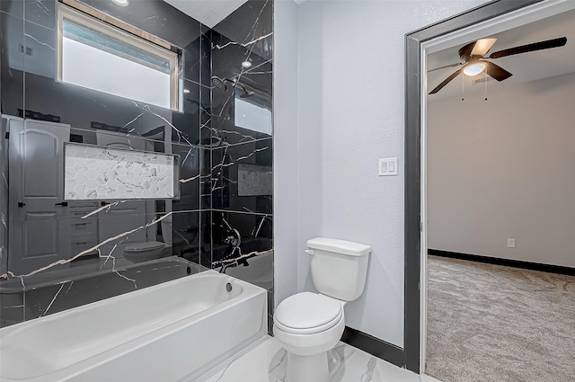 full bathroom featuring a tub, toilet, baseboards, marble finish floor, and a ceiling fan