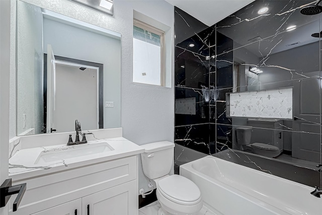 bathroom featuring a textured wall, toilet, and vanity
