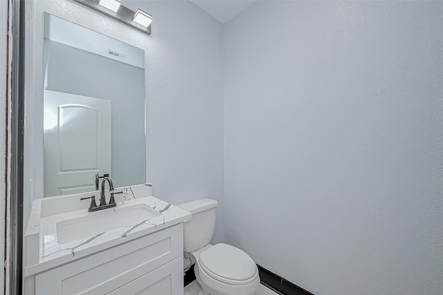 bathroom with toilet and vanity
