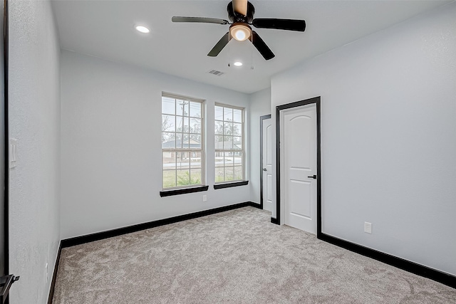 carpeted spare room with baseboards, visible vents, recessed lighting, and a ceiling fan