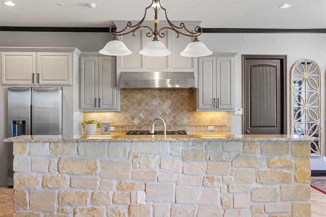 12606 Mostyn Ct, Magnolia, TX 77354 - kitchen with light stone counters, ventilation hood, crown molding, and stainless steel refrigerator with ice dispenser
