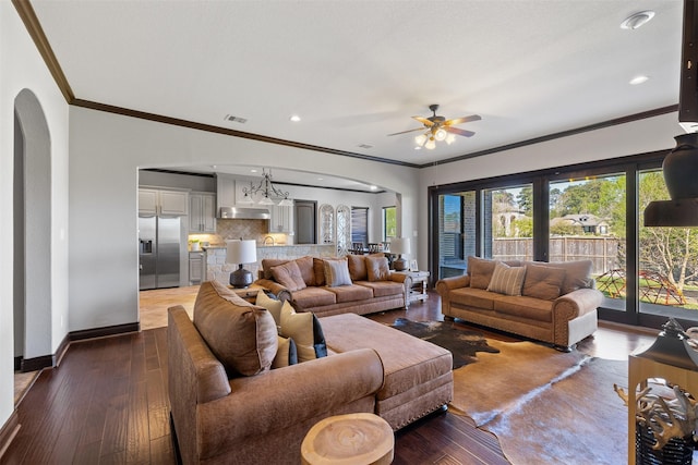 12606 Mostyn Ct, Magnolia, TX 77354 - living area featuring crown molding, arched walkways, baseboards, and visible vents