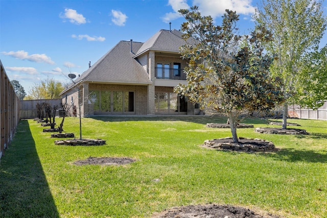 12606 Mostyn Ct, Magnolia, TX 77354 - rear view of property featuring a balcony, a yard, brick siding, and a fenced backyard