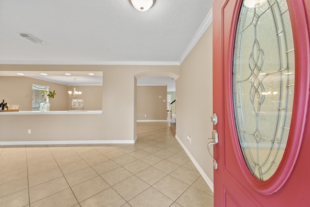 1231 Kings Creek Trl, Missouri City, TX 77459 - entryway featuring light tile patterned floors, baseboards, arched walkways, an inviting chandelier, and crown molding