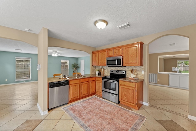 1231 Kings Creek Trl, Missouri City, TX 77459 - kitchen featuring appliances with stainless steel finishes, light tile patterned flooring, a sink, and visible vents
