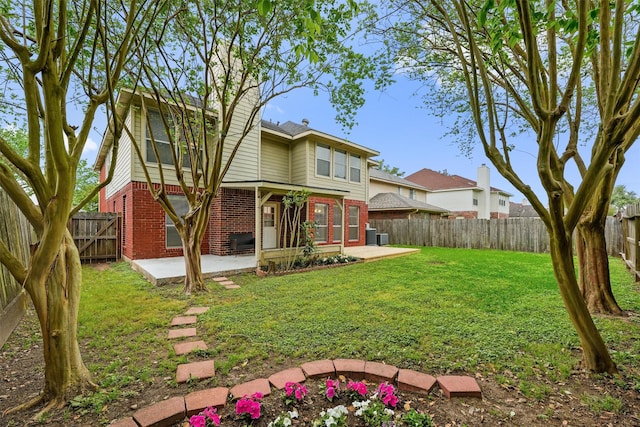 1231 Kings Creek Trl, Missouri City, TX 77459 - rear view of house with a patio area, brick siding, a fenced backyard, and a lawn