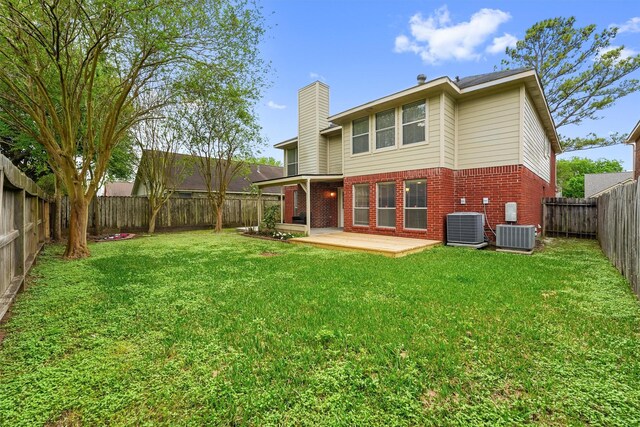 1231 Kings Creek Trl, Missouri City, TX 77459 - rear view of house with a yard, a chimney, a fenced backyard, central air condition unit, and brick siding