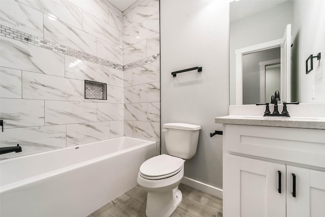 bathroom featuring toilet, vanity,  shower combination, wood finished floors, and baseboards