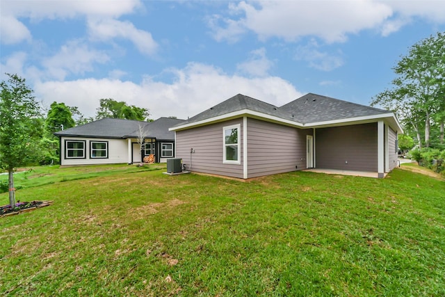 rear view of property with a lawn