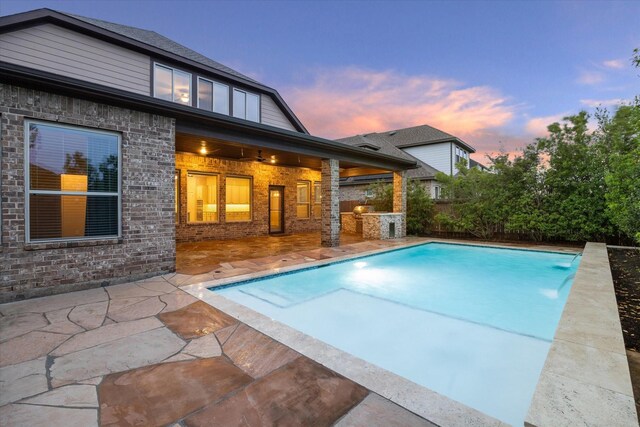 31021 Harvest Meadow Ln, Spring, TX 77386 - pool at dusk with a patio and an outdoor pool