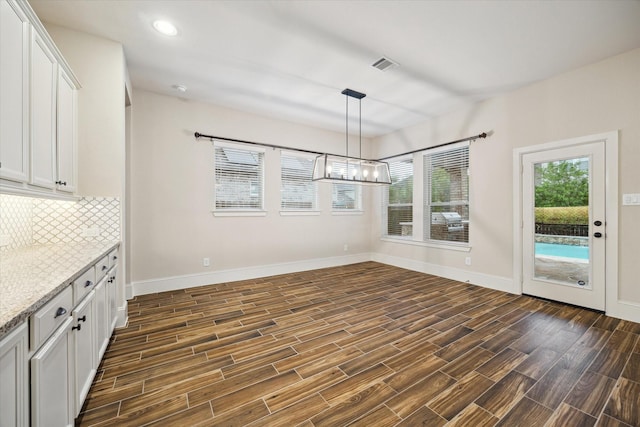 31021 Harvest Meadow Ln, Spring, TX 77386 - unfurnished dining area with a chandelier, dark wood-style floors, and recessed lighting