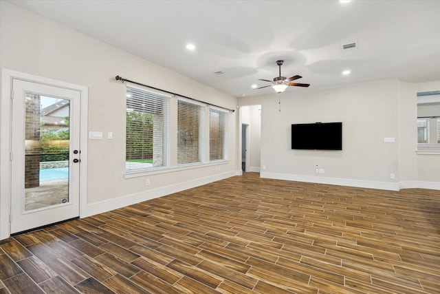31021 Harvest Meadow Ln, Spring, TX 77386 - unfurnished living room with wood finished floors, ceiling fan, and recessed lighting