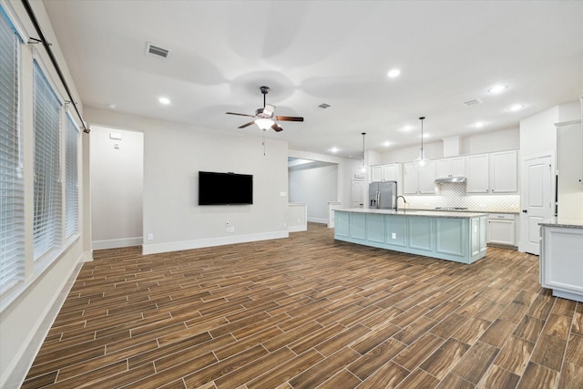 31021 Harvest Meadow Ln, Spring, TX 77386 - kitchen with stainless steel fridge with ice dispenser, white cabinets, tasteful backsplash, a ceiling fan, and dark wood finished floors