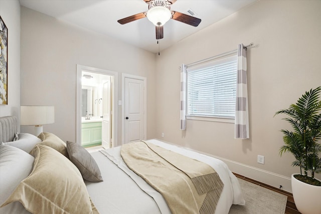 31021 Harvest Meadow Ln, Spring, TX 77386 - bedroom with baseboards, wood finished floors, ensuite bath, and ceiling fan