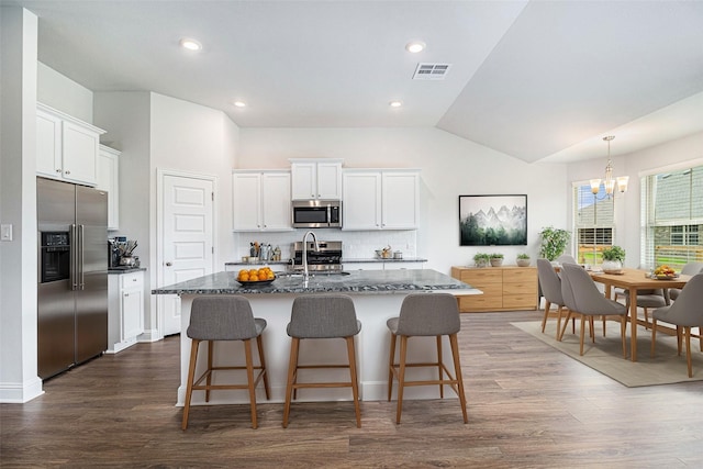 4214 Leslies Way, Dickinson, TX 77539 - kitchen with appliances with stainless steel finishes, a sink, a chandelier, decorative backsplash, and an island with sink