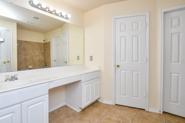 full bath featuring visible vents, vanity, a shower, baseboards, and tile patterned floors