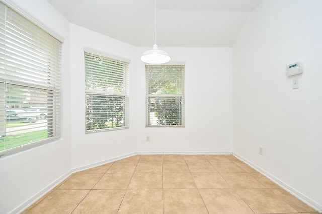 unfurnished dining area with baseboards and light tile patterned floors