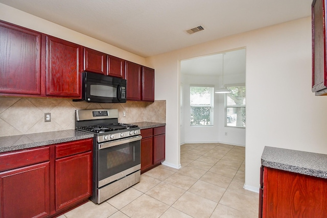 kitchen with black microwave, visible vents, stainless steel gas stove, and dark brown cabinets