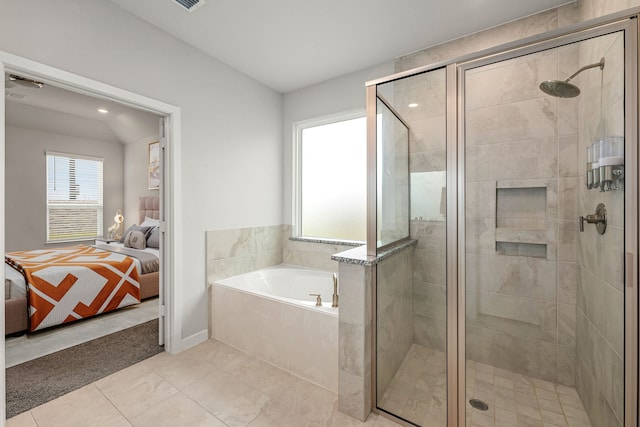 bathroom featuring a bath, ensuite bath, and a stall shower