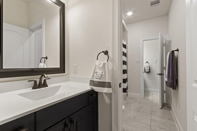 1002 Timberland Bay Ct, Pinehurst, TX 77362 - full bathroom with visible vents, baseboards, toilet, vanity, and tile patterned flooring