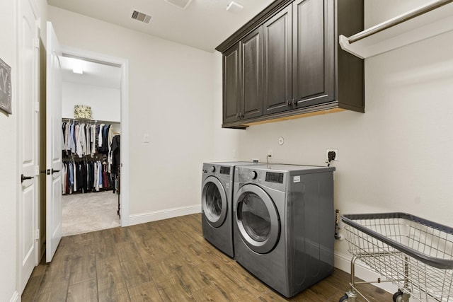 1002 Timberland Bay Ct, Pinehurst, TX 77362 - laundry room featuring baseboards, visible vents, washer and clothes dryer, cabinet space, and dark wood finished floors