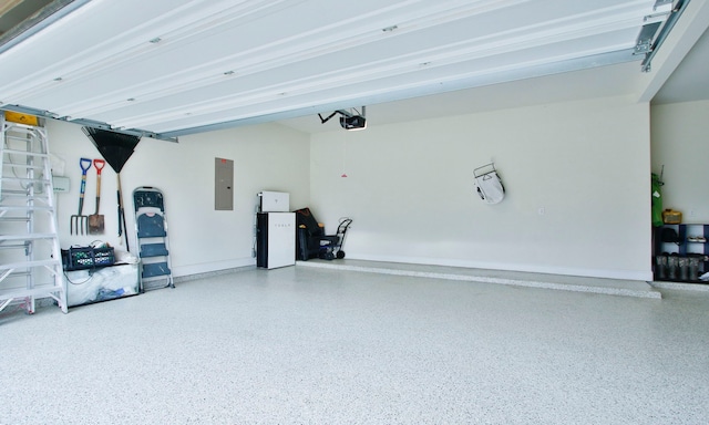 1002 Timberland Bay Ct, Pinehurst, TX 77362 - garage featuring baseboards, a garage door opener, and electric panel