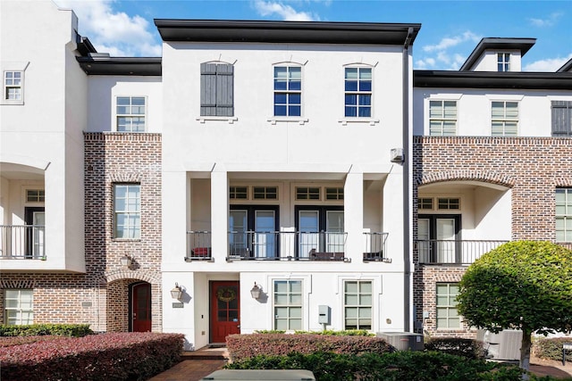 multi unit property with stucco siding and cooling unit