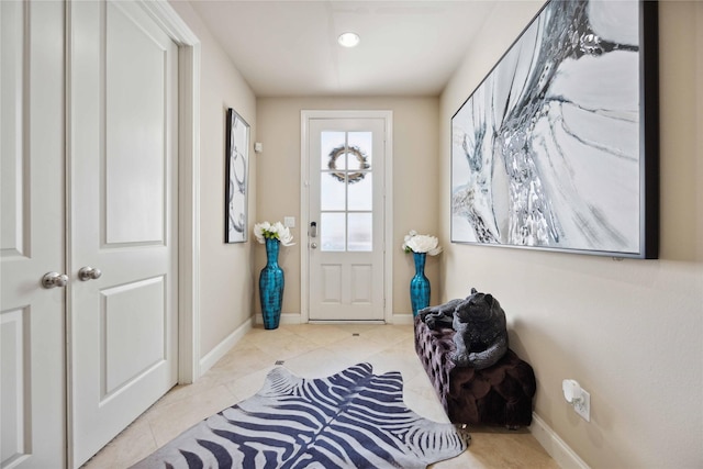 entryway with tile patterned flooring and baseboards