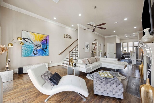 living room with wood finished floors, stairway, and a ceiling fan