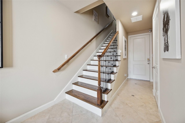 staircase featuring baseboards, recessed lighting, visible vents, and tile patterned flooring