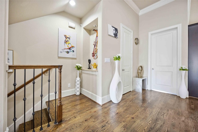hallway featuring crown molding, an upstairs landing, wood finished floors, lofted ceiling, and baseboards