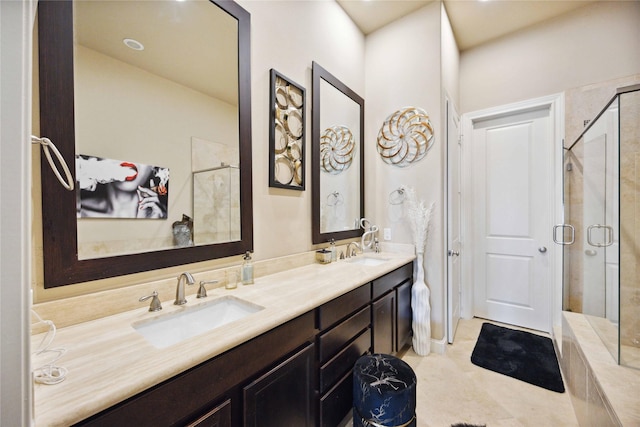 bathroom with double vanity, a sink, tile patterned flooring, and a shower stall
