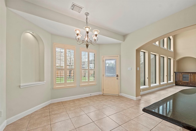 11812 Sea Shadow Bnd, Pearland, TX 77584 - entryway with tile patterned flooring, a chandelier, and arched walkways