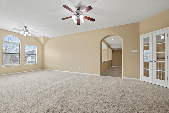11812 Sea Shadow Bnd, Pearland, TX 77584 - empty room with a ceiling fan, arched walkways, carpet flooring, and french doors