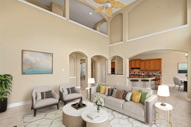 11812 Sea Shadow Bnd, Pearland, TX 77584 - living area featuring arched walkways, a towering ceiling, and light tile patterned flooring
