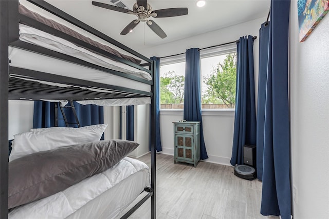 bedroom with baseboards, recessed lighting, wood finished floors, and ceiling fan
