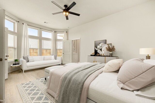 149 Sunray Creek Dr, Katy, TX 77493 - bedroom with light wood-type flooring, a ceiling fan, multiple windows, and visible vents